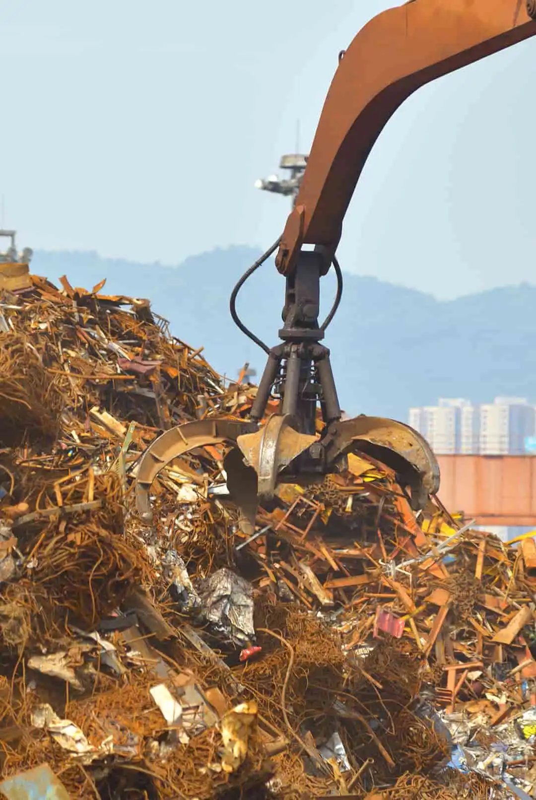 Heavy machinery sorting scrap metal in an industrial recycling facility in Brisbane, Australia